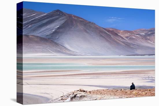 Man Sitting on Rocks at Miscanti Volcano and High Plateau Lagoon in San Pedro De Atacama Desert-Kimberly Walker-Stretched Canvas