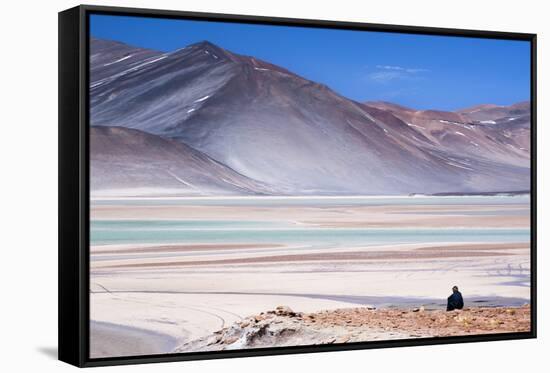 Man Sitting on Rocks at Miscanti Volcano and High Plateau Lagoon in San Pedro De Atacama Desert-Kimberly Walker-Framed Stretched Canvas