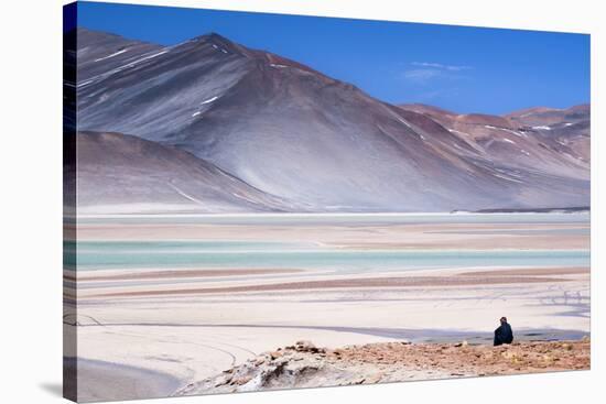 Man Sitting on Rocks at Miscanti Volcano and High Plateau Lagoon in San Pedro De Atacama Desert-Kimberly Walker-Stretched Canvas