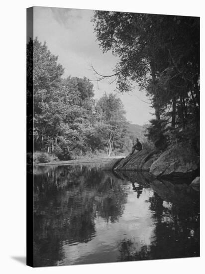 Man Sitting on the Bank of the Upper Opalescent River, a Branch of the Hudson-Margaret Bourke-White-Stretched Canvas
