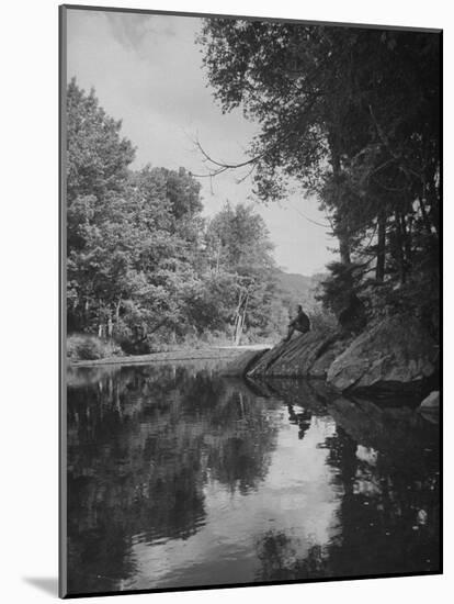 Man Sitting on the Bank of the Upper Opalescent River, a Branch of the Hudson-Margaret Bourke-White-Mounted Photographic Print
