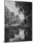 Man Sitting on the Bank of the Upper Opalescent River, a Branch of the Hudson-Margaret Bourke-White-Mounted Photographic Print