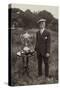 Man Standing Beside Bowls Trophies-null-Stretched Canvas