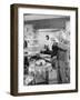 Man Standing in His Living Room Playing the Trumpet to a Bird-null-Framed Photo