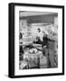 Man Standing in His Living Room Playing the Trumpet to a Bird-null-Framed Photo