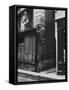 Man Standing on a Balcony over a Lamp Post on the Rue de La Huchette-David Scherman-Framed Stretched Canvas