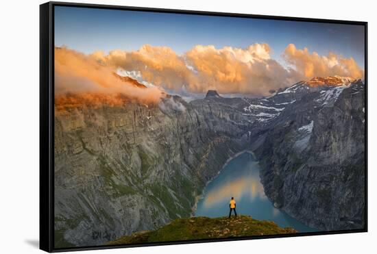 Man standing on rocks looking at clouds at sunset over lake Limmernsee, aerial view-Roberto Moiola-Framed Stretched Canvas