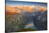 Man standing on rocks looking at clouds at sunset over lake Limmernsee, aerial view-Roberto Moiola-Stretched Canvas