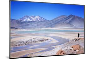 Man Standing on Rocks Looking over Miscanti Laguna, Turquoise Mineral Lake, San Pedro De Atacama-Kimberly Walker-Mounted Photographic Print