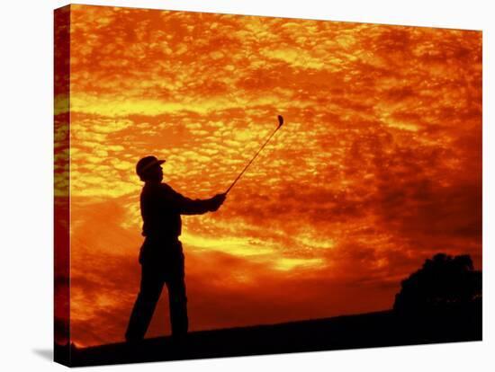 Man Swinging Golf Club at Sunset-Bill Bachmann-Stretched Canvas