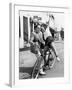 Man Trying to Balance an Exuberant Woman on a Bicycle-null-Framed Photo