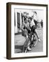 Man Trying to Balance an Exuberant Woman on a Bicycle-null-Framed Photo