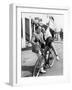 Man Trying to Balance an Exuberant Woman on a Bicycle-null-Framed Photo