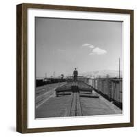 Man Walking Atop a Freight Train Heading Westbound-Sam Shere-Framed Photographic Print