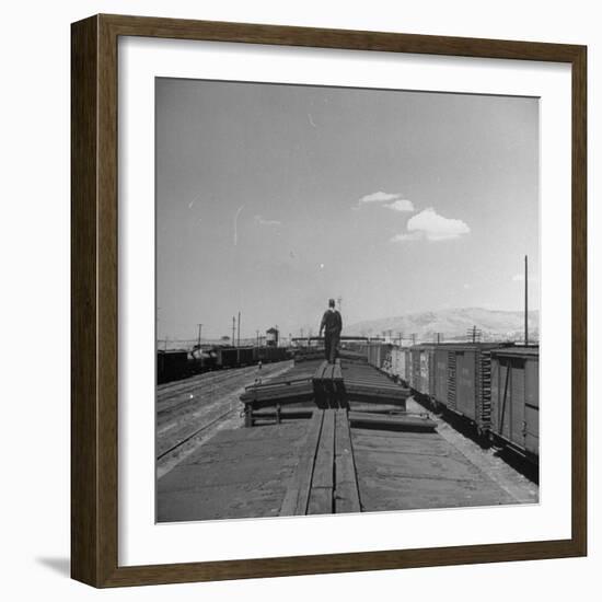 Man Walking Atop a Freight Train Heading Westbound-Sam Shere-Framed Photographic Print