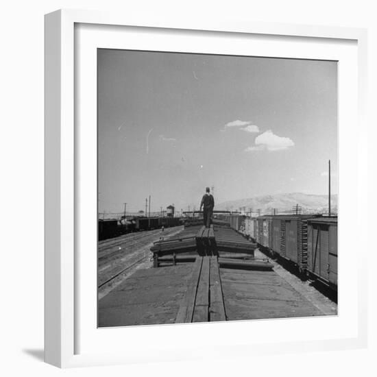 Man Walking Atop a Freight Train Heading Westbound-Sam Shere-Framed Photographic Print