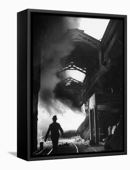 Man Walking in the Smokey Steel Mill-Nat Farbman-Framed Stretched Canvas