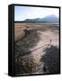 Man Walking on Dry Lake Bed with Llaima Volcano in Distance, Conguillio National Park, Chile-Aaron McCoy-Framed Stretched Canvas