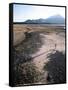 Man Walking on Dry Lake Bed with Llaima Volcano in Distance, Conguillio National Park, Chile-Aaron McCoy-Framed Stretched Canvas