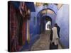 Man Walking Through Pastel Coloured Streets of Chefchaouen, Morocco, North Africa, Africa-Christian Kober-Stretched Canvas