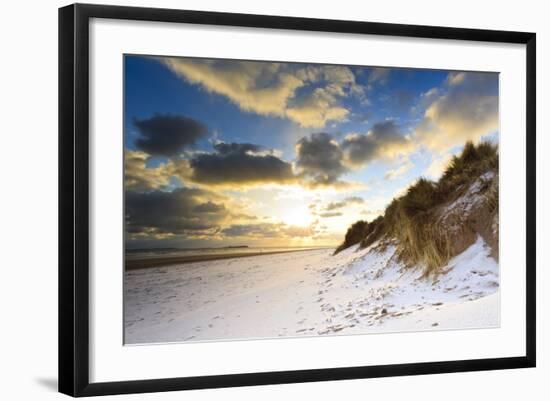 Man Walks Dog on Snow Covered Bamburgh Beach at Dawn with View to Farne Islands-Eleanor-Framed Photographic Print