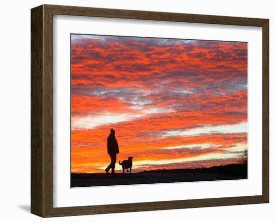 Man Walks His Dog under a Red Sky in the Afternoon Hours in Frankfurt, Central Germany-null-Framed Photographic Print