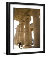 Man Walks Underneath the Giant Columns of the Hypostyle Hall in the Ramesseum, Luxor-Julian Love-Framed Photographic Print