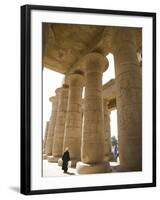 Man Walks Underneath the Giant Columns of the Hypostyle Hall in the Ramesseum, Luxor-Julian Love-Framed Photographic Print