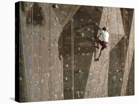 Man Wall Climbing Indoors with Equipment-null-Stretched Canvas