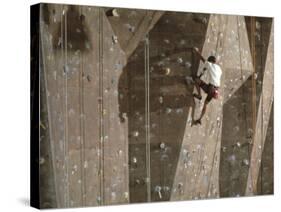 Man Wall Climbing Indoors with Equipment-null-Stretched Canvas