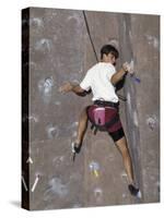 Man Wall Climbing Indoors with Equipment-null-Stretched Canvas