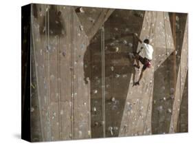 Man Wall Climbing Indoors with Equipment-null-Stretched Canvas