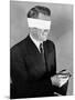 Man Wearing Blindfold Holding Money (B&W)-Hulton Archive-Mounted Photographic Print