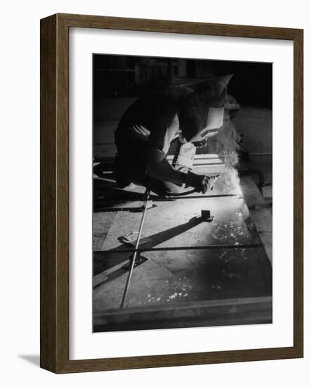 Man Welding Pieces of Metal Together-Allan Grant-Framed Photographic Print