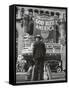 Man with Shopping Bags in Front of Million Dollar Theatre Emblazoned with God Bless America Banner-Bob Landry-Framed Stretched Canvas