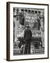 Man with Shopping Bags in Front of Million Dollar Theatre Emblazoned with God Bless America Banner-Bob Landry-Framed Photographic Print