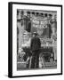 Man with Shopping Bags in Front of Million Dollar Theatre Emblazoned with God Bless America Banner-Bob Landry-Framed Photographic Print