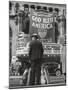 Man with Shopping Bags in Front of Million Dollar Theatre Emblazoned with God Bless America Banner-Bob Landry-Mounted Photographic Print