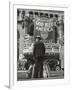 Man with Shopping Bags in Front of Million Dollar Theatre Emblazoned with God Bless America Banner-Bob Landry-Framed Photographic Print