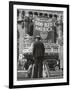 Man with Shopping Bags in Front of Million Dollar Theatre Emblazoned with God Bless America Banner-Bob Landry-Framed Photographic Print