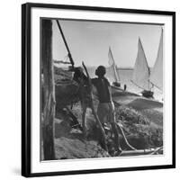 Man Working with Irrigation System as Sailboats Sit at Edge of Nile River at Wadi Halfa-null-Framed Photographic Print