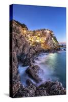 Manarola Village Illuminated by the Blue Light of Dusk with its Typical Pastel Colored Houses-ClickAlps-Stretched Canvas