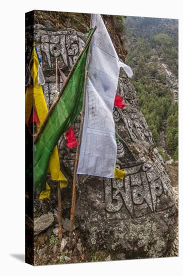 Mani Stone and prayer flags along a trail, Nepal.-Lee Klopfer-Stretched Canvas