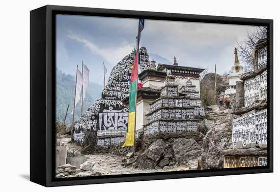 Mani Stones and prayer flags on a trail, Nepal.-Lee Klopfer-Framed Stretched Canvas