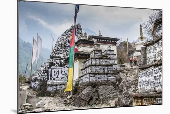 Mani Stones and prayer flags on a trail, Nepal.-Lee Klopfer-Mounted Photographic Print