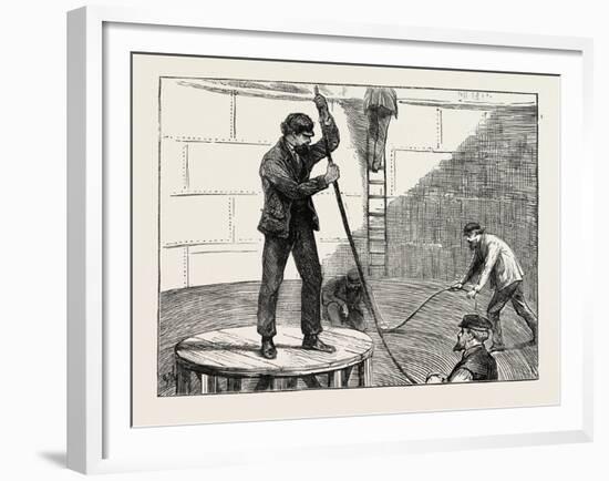 Manufacturing an Electric Telegraph Cable: Coiling Down the Cable in the Tank, 1873-null-Framed Giclee Print