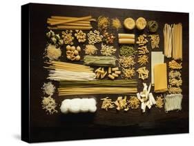 Many Different Types of Pasta on Dark Wooden Background-Walter Cimbal-Stretched Canvas
