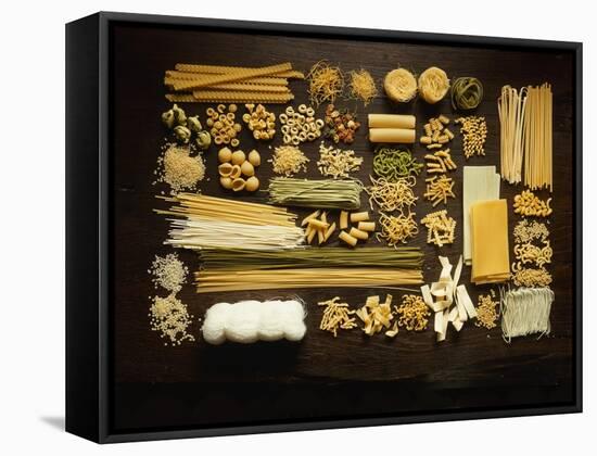 Many Different Types of Pasta on Dark Wooden Background-Walter Cimbal-Framed Stretched Canvas