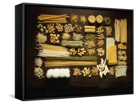 Many Different Types of Pasta on Dark Wooden Background-Walter Cimbal-Framed Stretched Canvas