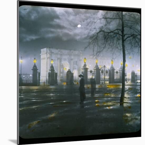 Marble Arch by Night - a Figure Standing in Front of the Park Gates-null-Mounted Photographic Print